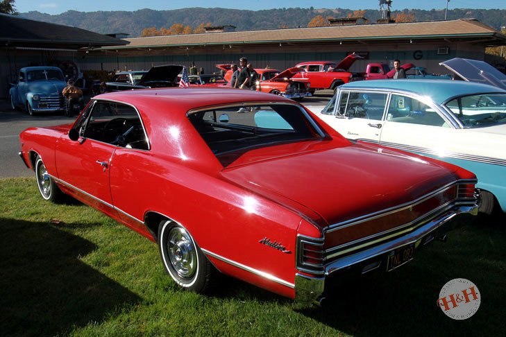 Classic red Malibu with white wall tires
